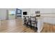 Open-concept kitchen featuring island with bar stools, stainless steel appliances, and living area at 11343 E 163Rd Ct, Brighton, CO 80602
