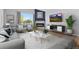 Bright living room with large window, fireplace, comfortable seating, and stylish decor at 11343 E 163Rd Ct, Brighton, CO 80602