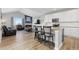 Open-concept living and kitchen area with vaulted ceilings, a fireplace, modern appliances, and island seating at 11343 E 163Rd Ct, Brighton, CO 80602