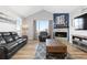 Cozy living room with a fireplace, comfortable seating, and large windows offering natural light at 11343 E 163Rd Ct, Brighton, CO 80602
