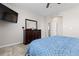 Another view of the main bedroom featuring dresser, mirror, and blue bedding at 11343 E 163Rd Ct, Brighton, CO 80602