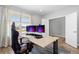 Well-lit office featuring desk, comfortable chair, and large windows offering natural light and neighborhood views at 11343 E 163Rd Ct, Brighton, CO 80602