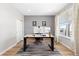 Comfortable home office with gray accent wall, wood floors, a modern desk, and bright natural light at 11343 E 163Rd Ct, Brighton, CO 80602