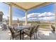Inviting covered patio area with dining table, comfortable chairs, and scenic outdoor views at 11343 E 163Rd Ct, Brighton, CO 80602