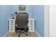 Compact study features blue accent wall, white cabinetry, and neutral carpeting at 11343 E 163Rd Ct, Brighton, CO 80602