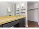 Bathroom featuring a bright vanity and a walk-in closet at 6455 E Bates Ave # 4-105, Denver, CO 80222