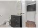 This bathroom has a dark vanity with a sink and tiled floors, along with a laundry room at 6455 E Bates Ave # 4-105, Denver, CO 80222