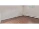 A bright bedroom is shown with hardwood floors and a large window at 6455 E Bates Ave # 4-105, Denver, CO 80222