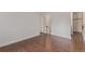 Bedroom featuring wood-look flooring and access to an ensuite bathroom and a walk-in closet at 6455 E Bates Ave # 4-105, Denver, CO 80222