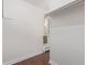 Walk-in closet featuring wood-look flooring and ample storage space at 6455 E Bates Ave # 4-105, Denver, CO 80222