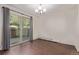 Living room with a sliding glass door to a private patio, wood-look floors, and natural lighting at 6455 E Bates Ave # 4-105, Denver, CO 80222