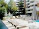 This community pool offers lounge chairs and umbrellas with the condos in the background at 6455 E Bates Ave # 4-105, Denver, CO 80222