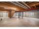 Unfinished basement offering ample space and exposed ceiling beams, ready for customization at 5214 S Tibet St, Aurora, CO 80015