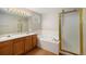 Elegant bathroom with double vanity, soaking tub, and separate shower with gold trim at 5214 S Tibet St, Aurora, CO 80015