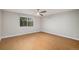 Spacious bedroom with hardwood floors, a ceiling fan, and a large window at 5214 S Tibet St, Aurora, CO 80015