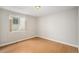 Bright bedroom with hardwood floors and a window at 5214 S Tibet St, Aurora, CO 80015