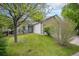 Charming home featuring a well-manicured lawn, mature trees, and a cozy front porch at 5214 S Tibet St, Aurora, CO 80015