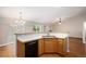 Functional kitchen with a breakfast bar, stainless steel sink, and an open layout connecting to the living space at 5214 S Tibet St, Aurora, CO 80015