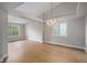Bright living room with hardwood floors, chandelier, and ample natural light at 5214 S Tibet St, Aurora, CO 80015
