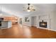 Open-concept living room with fireplace, ceiling fan, and natural light from the sliding glass doors at 5214 S Tibet St, Aurora, CO 80015