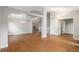 Spacious living room featuring wood floors, a modern chandelier, and neutral paint at 5214 S Tibet St, Aurora, CO 80015
