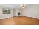 Cozy living room featuring hardwood floors and fireplace, illuminated by natural light at 5214 S Tibet St, Aurora, CO 80015