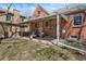 Spacious backyard featuring a covered patio and well-maintained lawn at 1615 Kearney St, Denver, CO 80220