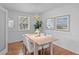 Bright dining room with wood floors, a large window, and seating for six at 1615 Kearney St, Denver, CO 80220