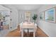 Bright dining room with wood floors, a large window, and modern lighting at 1615 Kearney St, Denver, CO 80220
