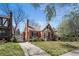 Charming brick home with well-maintained lawn, mature trees, and welcoming front porch offering classic curb appeal at 1615 Kearney St, Denver, CO 80220