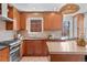 Modern kitchen with custom wood cabinets, stainless steel appliances, and tile backsplash exudes a blend of elegance and functionality at 1615 Kearney St, Denver, CO 80220