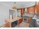 This kitchen features stainless steel appliances, a gas range, and a kitchen island with microwave at 1615 Kearney St, Denver, CO 80220