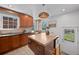 Modern kitchen with custom wood cabinets, an island, and stainless steel appliances exudes a blend of elegance and functionality at 1615 Kearney St, Denver, CO 80220