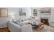 Bright living room boasts hardwood floors, a fireplace, and comfortable seating creating a cozy and inviting atmosphere at 1615 Kearney St, Denver, CO 80220