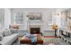 Inviting living room features a fireplace, built-in benches, and a stylish ottoman for a comfortable and elegant ambiance at 1615 Kearney St, Denver, CO 80220