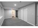 Spacious finished basement room with grey carpet and ensuite bathroom at 4575 Gibraltar St, Denver, CO 80249