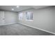 Finished basement with grey carpet and two large windows at 4575 Gibraltar St, Denver, CO 80249