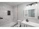 Clean bathroom with marble tile and updated fixtures at 4575 Gibraltar St, Denver, CO 80249