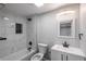 Basement bathroom with a single vanity, bathtub and modern fixtures at 4575 Gibraltar St, Denver, CO 80249