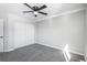 Spacious bedroom featuring grey carpet, double doors, and a ceiling fan at 4575 Gibraltar St, Denver, CO 80249