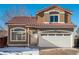 Two-story house with a brown exterior, red tile roof, and a white garage door at 4575 Gibraltar St, Denver, CO 80249