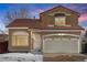 Two story house with a tan exterior and a two car garage at 4575 Gibraltar St, Denver, CO 80249