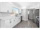 Renovated kitchen featuring white cabinets and quartz countertops at 4575 Gibraltar St, Denver, CO 80249