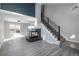 Living room featuring a fireplace, gray flooring and staircase at 4575 Gibraltar St, Denver, CO 80249