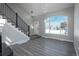 Living area with gray flooring, staircase, and a large window at 4575 Gibraltar St, Denver, CO 80249