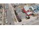 An aerial view shows colorful houses with well-manicured lawns along a tree-lined street at 2616 Emporia St, Denver, CO 80238