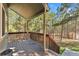The spacious porch features wooden railings and supports with forest views of the surrounding yard at 34103 Forest Park Dr, Elizabeth, CO 80107