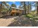 Exterior shot showing the back of a two story home, with a deck, patio, and fire pit at 34103 Forest Park Dr, Elizabeth, CO 80107