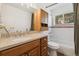 Bright bathroom features a wooden vanity with a light countertop and a tub and shower combination at 34103 Forest Park Dr, Elizabeth, CO 80107