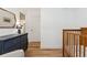Bedroom room featuring wood floors, a dark dresser, wooden crib, and neutral tones at 34103 Forest Park Dr, Elizabeth, CO 80107